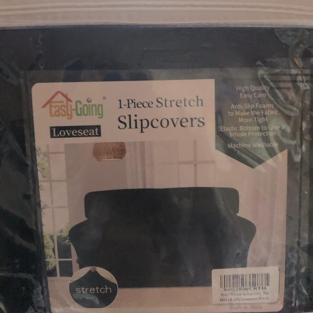 Brand new- never used loveseat cover / black